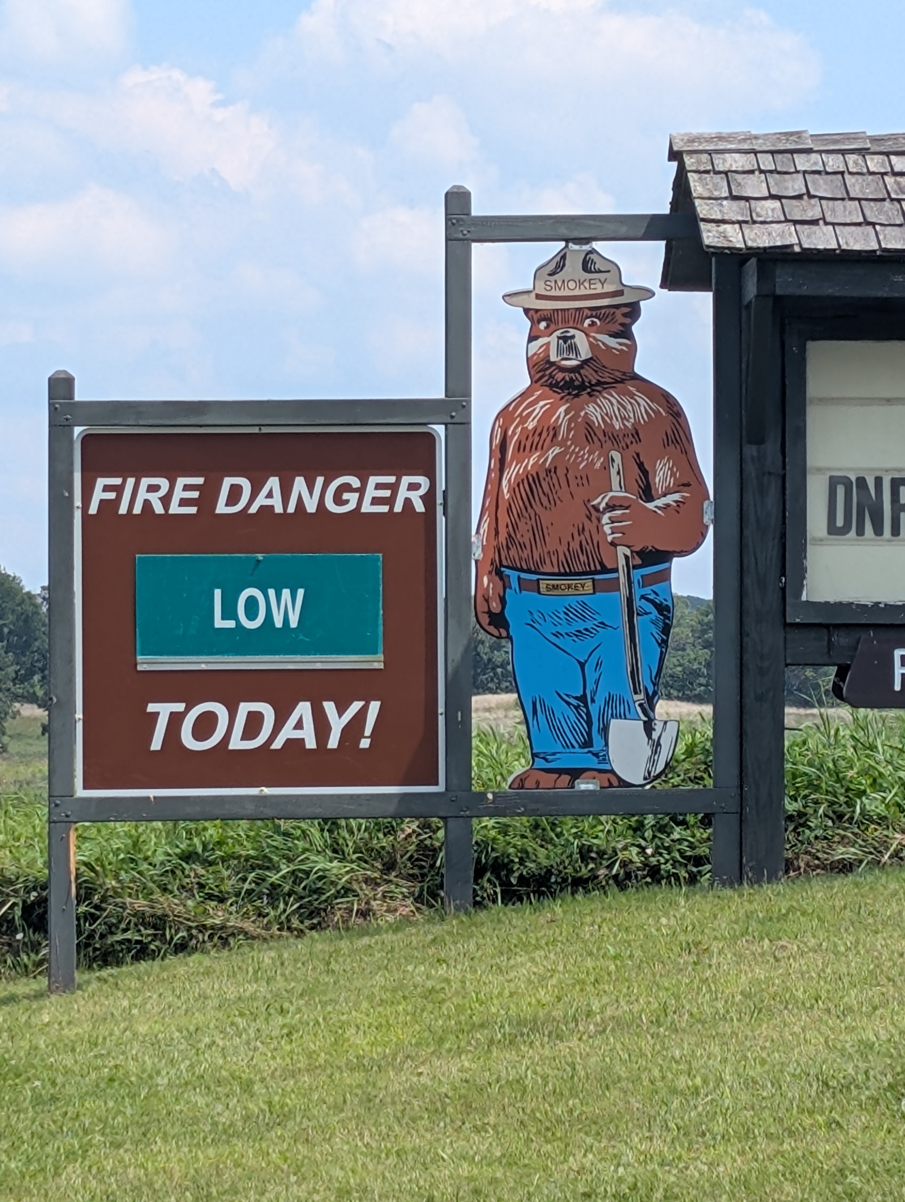 a Smokey the Bear sign, describing the danger of wildfires in the area as low